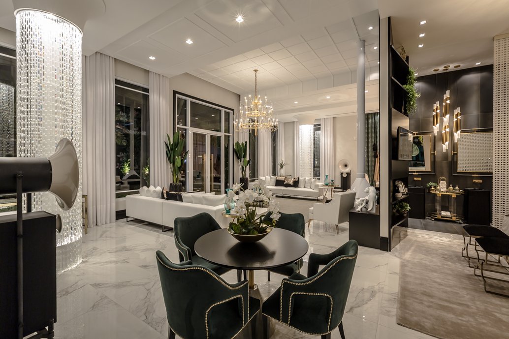 A iluminação dá o diferencial do projeto, mesclando pendentes, embutidos e até uma cascata de cristais envolvendo os 2 pilares do living ? emoldurando com ainda mais propriedade a simetria deste espaço. Foto: Henrique Kotaka