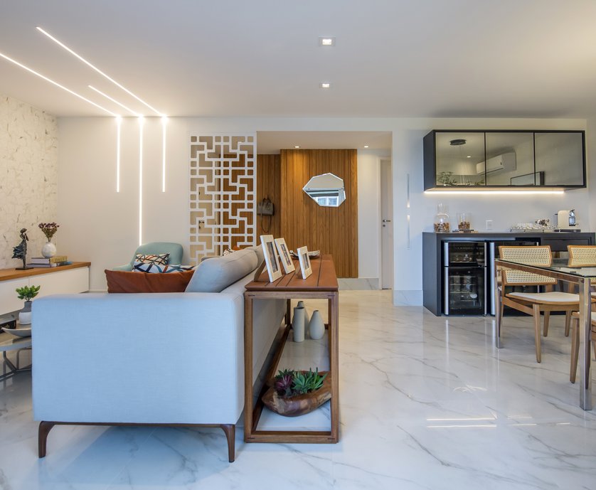 Foto: Marcio Irala. Projeto de reforma de apartamento seguindo estilo minimalista com piso único em toda a extensão da sala e varanda