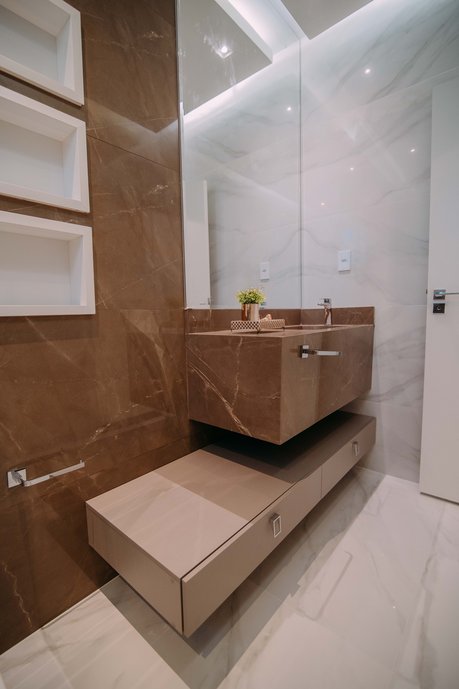 Banheiro clean e sofisticado com cuba esculpida em porcelanato.