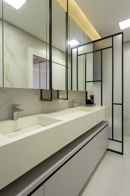 Banheiro com paleta de cores neutras, destaque para cuba esculpida em porcelanato.
